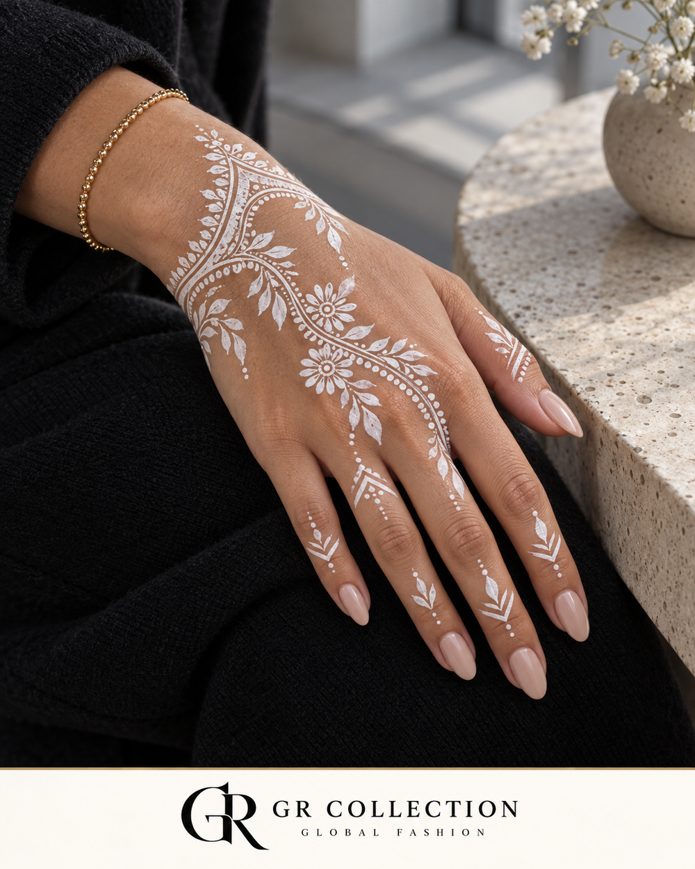 GR Collection design concept: white geometric lace and floral body art on a hand.