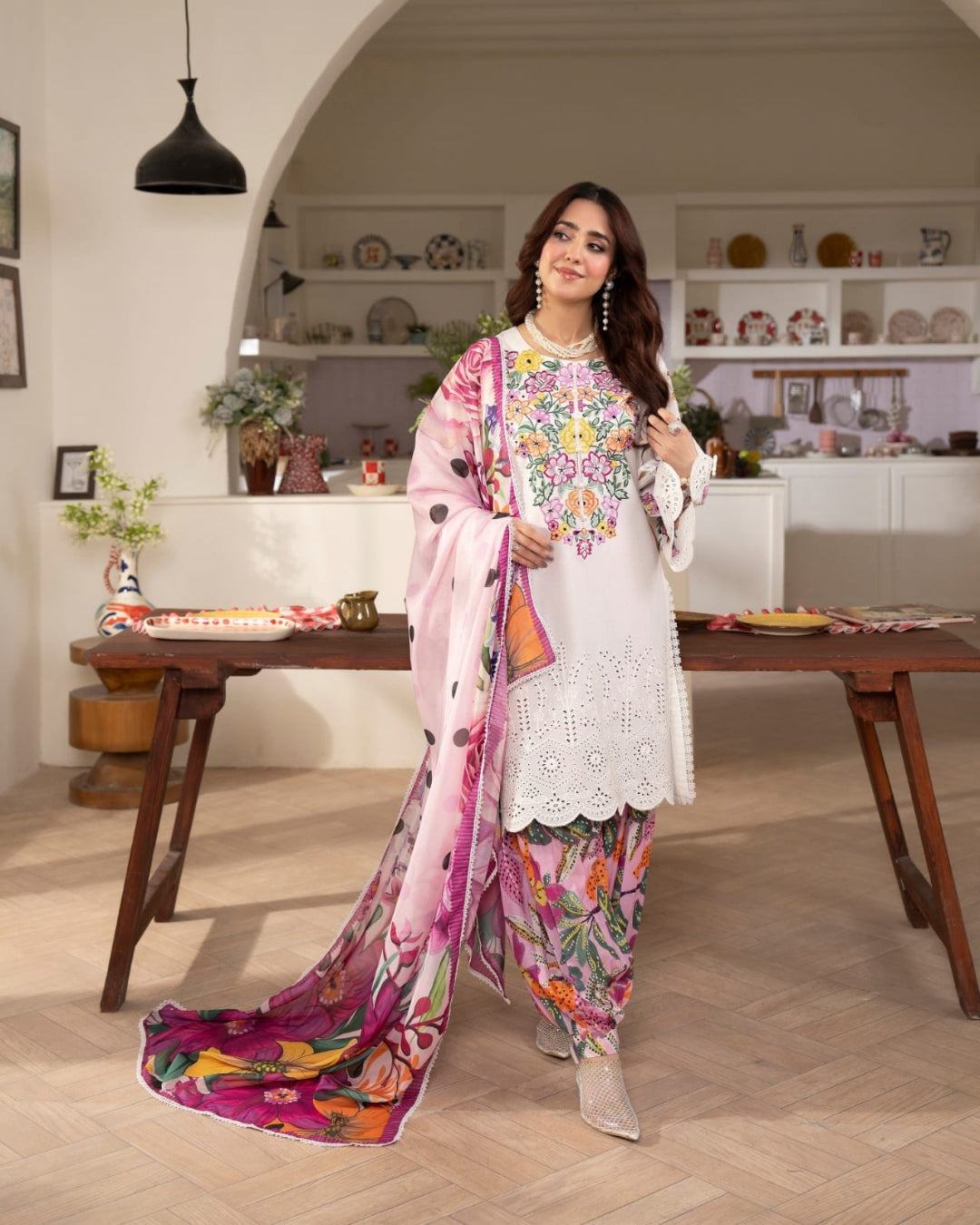 Ivory Pakistani three-piece suit with multicolour floral details and pink dupatta